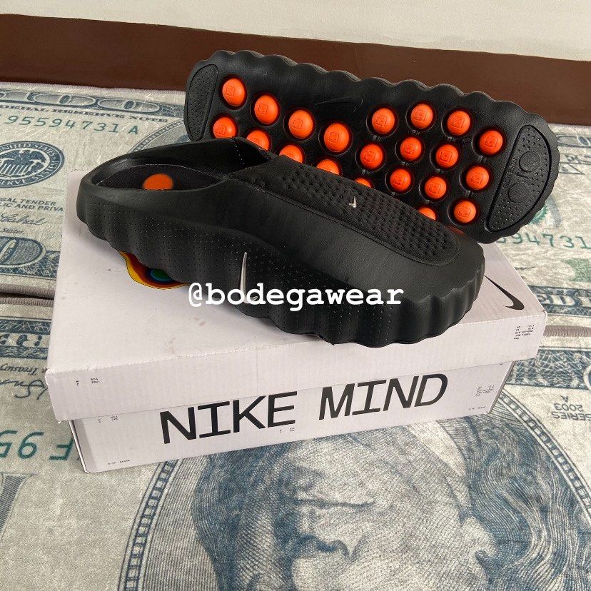 Nike Mind Slides Black Orange (Category: Slippers & Slides) located in Manila. Submitted by bodegawear_mnl (Listing ID 1465409235, Image 1). Description: - Model: Nike Mind Slides - Colorway: Black and Vibrant Orange - Design: Slip-on mule silhouette with a unique podular outsole and silver side Swoosh - Condition: Brand new with original Nike Mind box and tags - Perfect for daily casual wear or adding a pop of color to your fit.
