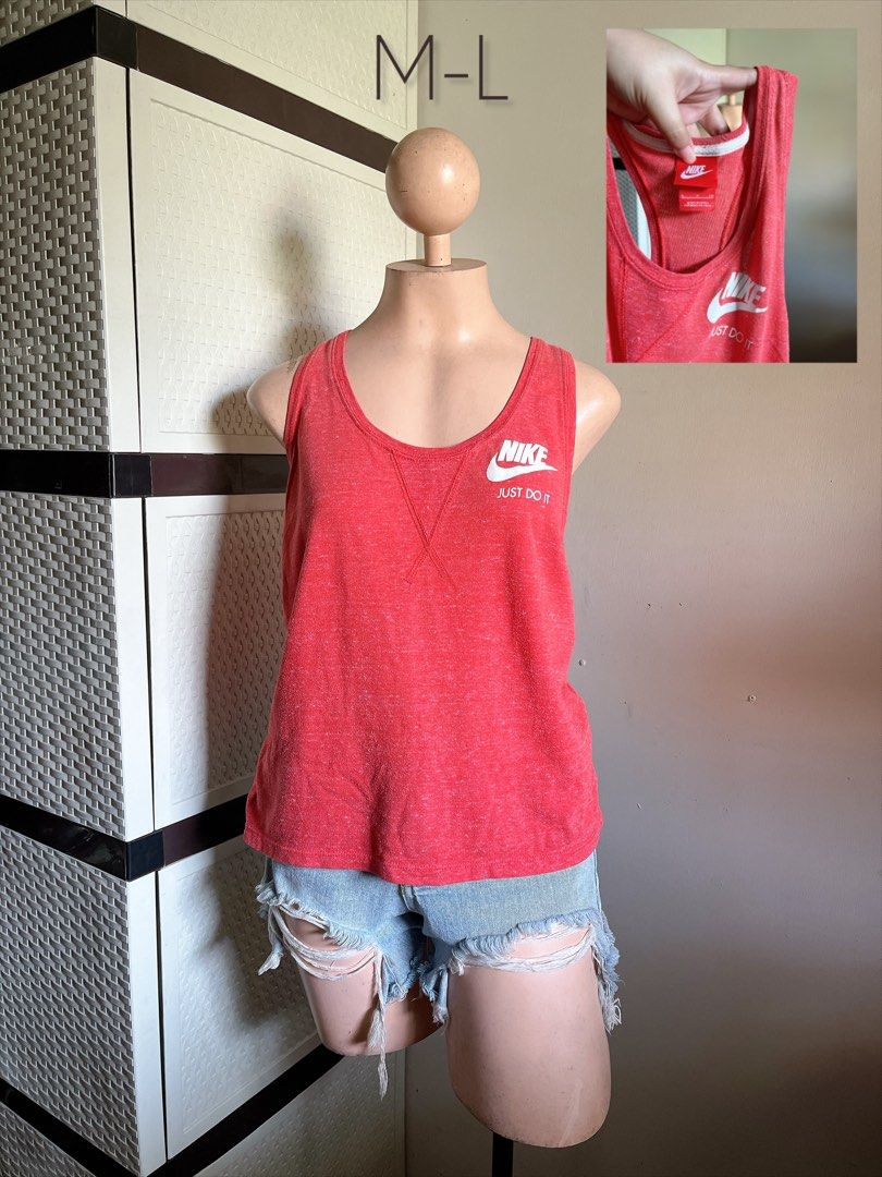 Nike Red Tank Top Just Do It Size M-L (Category: Sleeveless) located in Bulacan. Submitted by k.a_styleph (Listing ID 1465538349, Image 1). Description: - Brand: Nike - Color: Bright heather red with white logo - Size: M (fits comfortably like a Medium to Large) - Design: Classic 'Just Do It' print on upper left chest, sleeveless racerback cut - Condition: Great for workouts, gym sessions, or casual everyday wear.