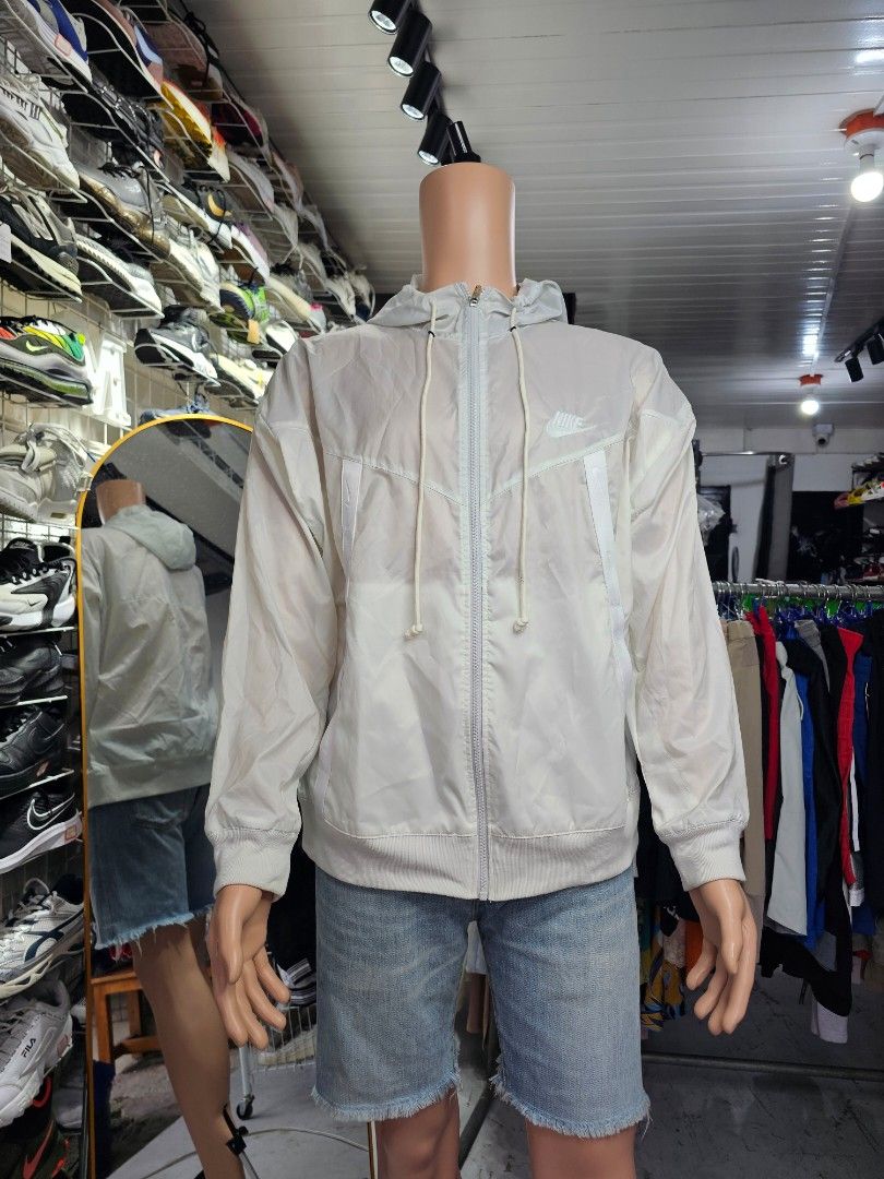 Nike Sportswear Windrunner full-zip hooded jacket (Category: Coats, Jackets and Outerwear) located in Baguio. Submitted by kayeonlineshop (Listing ID 1465430872, Image 1). Description: -Nike Sportswear Windrunner full-zip hooded jacket in a white or light-colored neutral tone featuring the classic chevron design lines..