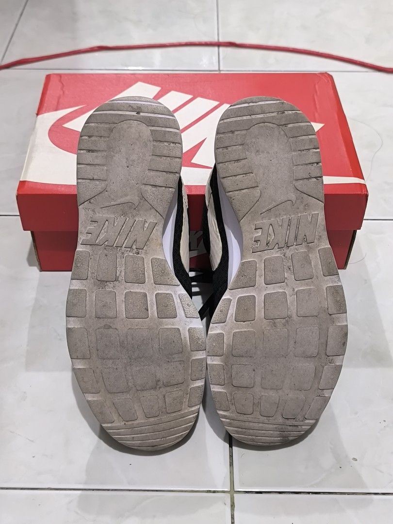 Nike Tanjun Black White Sneakers (Category: Sneakers) located in General Santos City (Dadiangas). Submitted by animoya (Listing ID 1461015367, Image 2). Description: - Size: US 7 - Flaws: Minor Peeling on Swoosh, Drag Marks - With Original Box.