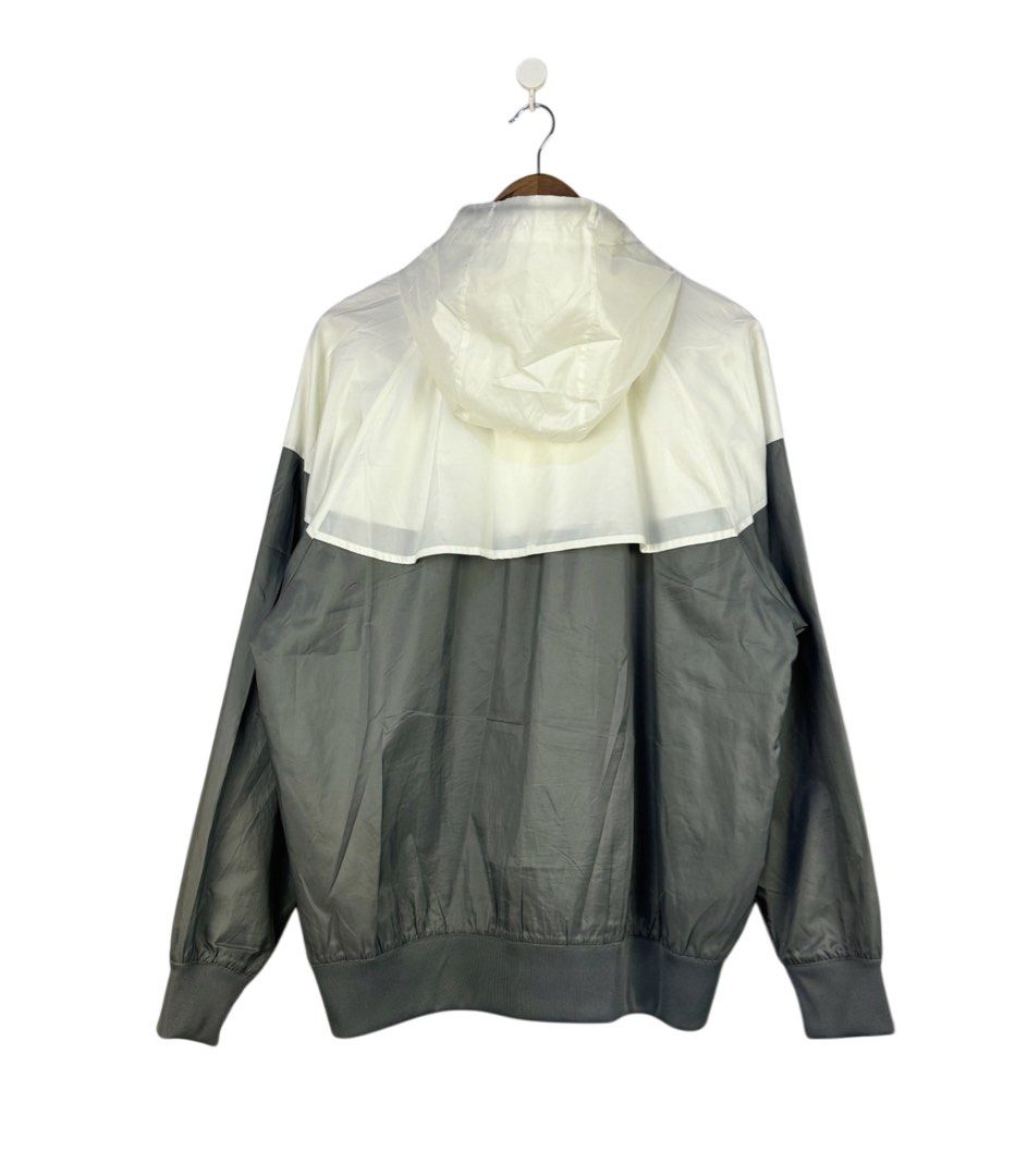 Nike The Windrunner Grey White Hooded Jacket Size L (Category: Coats, Jackets and Outerwear) located in Caloocan City. Submitted by mzcollection_349 (Listing ID 1465402331, Image 2). Description: - Brand: Nike - Style: Classic Windrunner colorblock jacket in grey and white - Design: Iconic chevron pattern across chest and back - Features: Full zip front, adjustable drawstring hood, two secure zippered side pockets - Details: Ribbed cuffs and hem 
