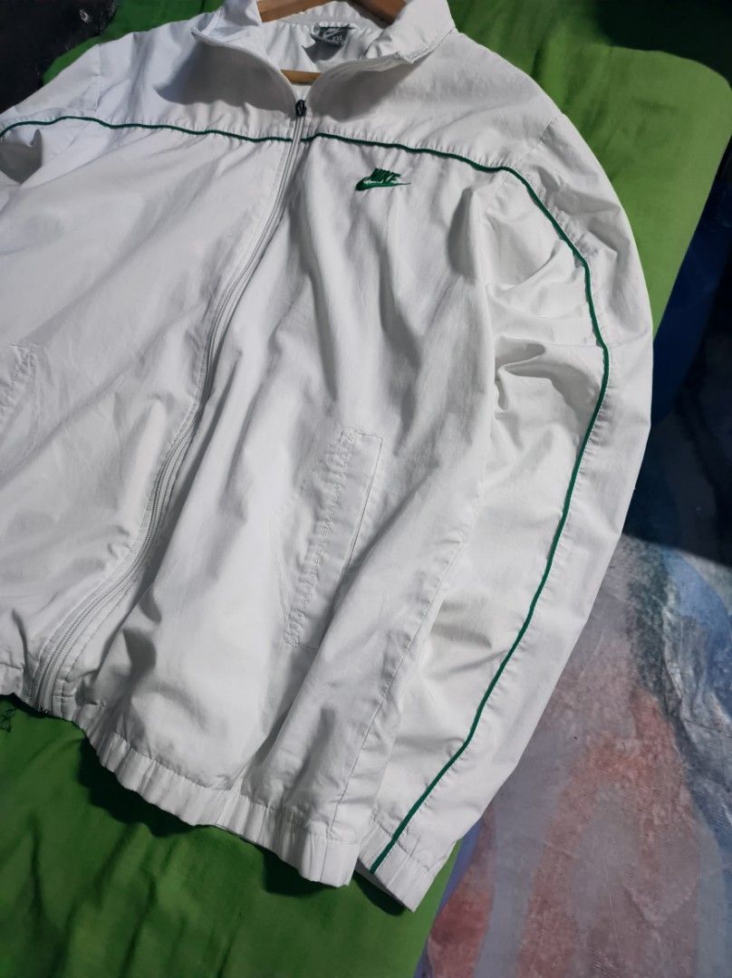 WHITE NIKE WINDBREAKER WITH GREEN LINES (Category: Coats, Jackets and Outerwear) located in Taguig. Submitted by steeze_plug (Listing ID 1465542446, Image 2). Description: Good Condition! Working well zipper Complete tags! (authentic piece) ✅ 10/10 color rate 🤍💚 Minimal scratches only Pogi neto! 🙌 Dimes: XL 23 width 28 length 🚛 J&T/FLASH EXPRESS delivery ➤ (Payment must be processed first) 🛵 Can also do Lalamove delivery if malapit ➤ (Can do