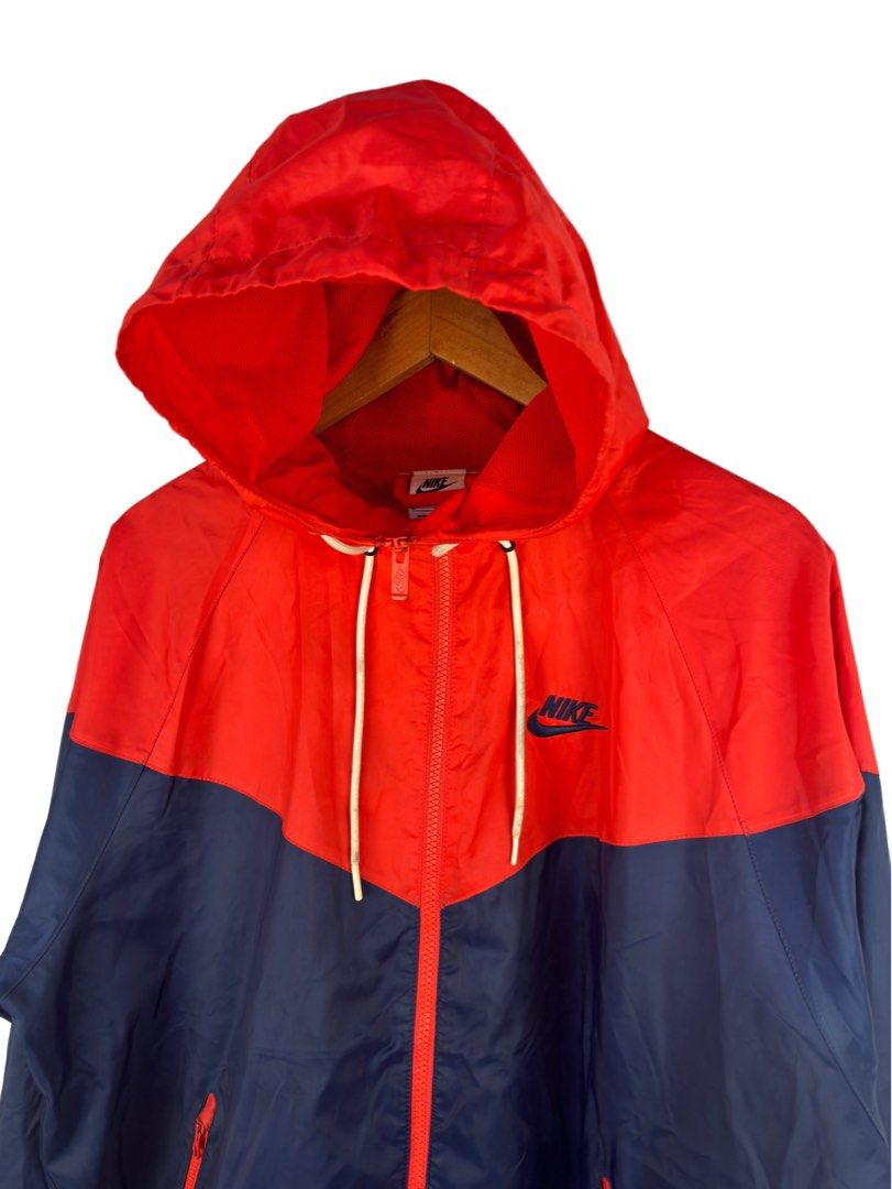 Nike Windrunner Hooded Jacket Red Blue Size M (Category: Coats, Jackets and Outerwear) located in Caloocan City. Submitted by mzcollection_349 (Listing ID 1465402538, Image 2). Description: - Brand: Nike - Style: Classic Windrunner Jacket - Colorway: Red and Navy Blue - Size: Medium (Made in Vietnam) - Dimensions: 25 inches across the chest, 27 inches in length - Features: Full zip front, red zippered hand pockets, adjustable drawstring hood with