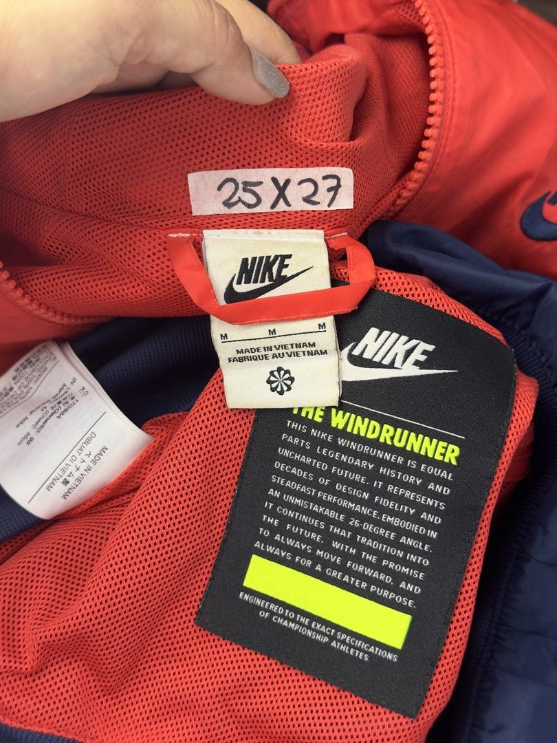 Nike Windrunner Hooded Jacket Red Blue Size M (Category: Coats, Jackets and Outerwear) located in Caloocan City. Submitted by mzcollection_349 (Listing ID 1465402538, Image 3). Description: - Brand: Nike - Style: Classic Windrunner Jacket - Colorway: Red and Navy Blue - Size: Medium (Made in Vietnam) - Dimensions: 25 inches across the chest, 27 inches in length - Features: Full zip front, red zippered hand pockets, adjustable drawstring hood with