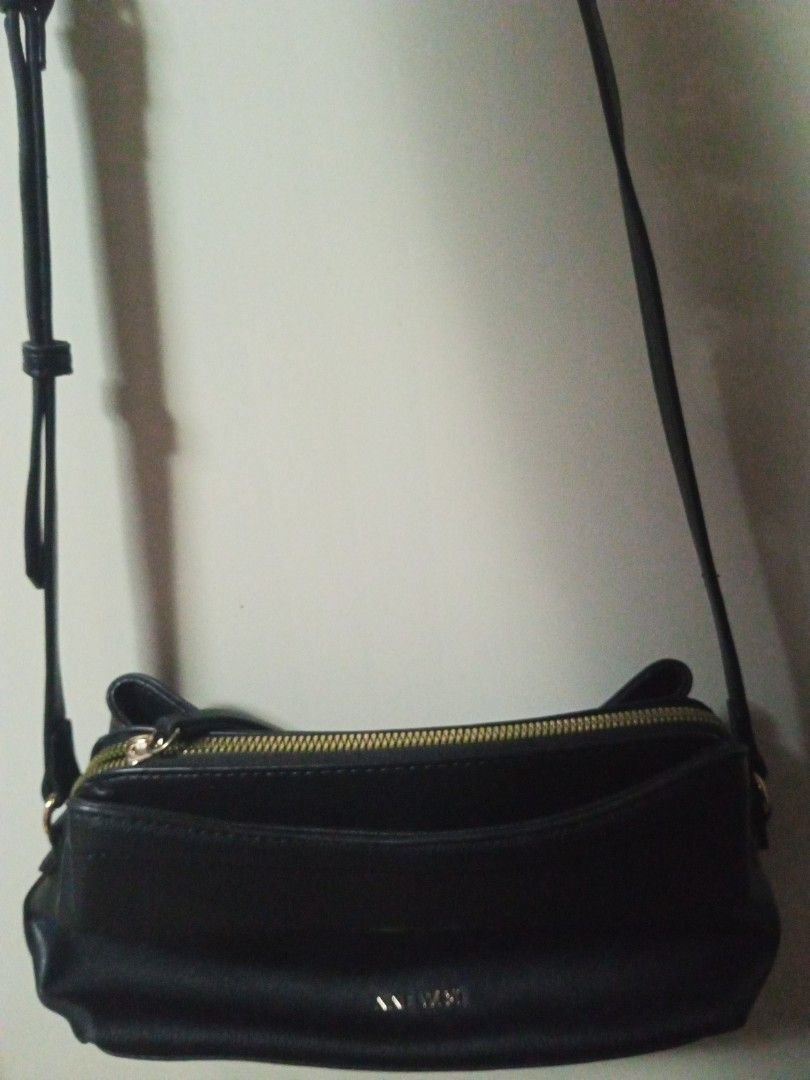 Nine West Black Crossbody Bag (Category: Cross-body Bags) located in Tagbilaran City. Submitted by margusatgil (Listing ID 1465421449, Image 1). Description: - Brand: Nine West - Color: Classic Black with chic gold-tone hardware - Material: Premium faux leather texture - Closure: Secure top zipper - Interior: Clean lining with handy slip pockets and multiple compartments - Strap: Adjustable for a custom fit - Style: Versatile and minimalist, perf