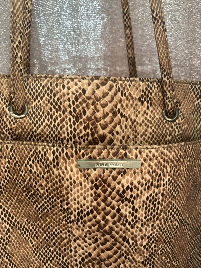 Nine West Tote Shoulder Bag (Category: Tote Bags) located in Quezon City. Submitted by rushcanon (Listing ID 1465404505, Image 3). Description: - Brand: Nine West - Condition: Clean inside and out with minimal signs of wear, perfect for everyday use 7.5/10 -Size: fits an iPad (10.2) - Material/Design: Chic brown snakeskin print with structured shape - Hardware: Silver-tone rings and metal brand plate - Straps: Double shoulder straps - Compartment