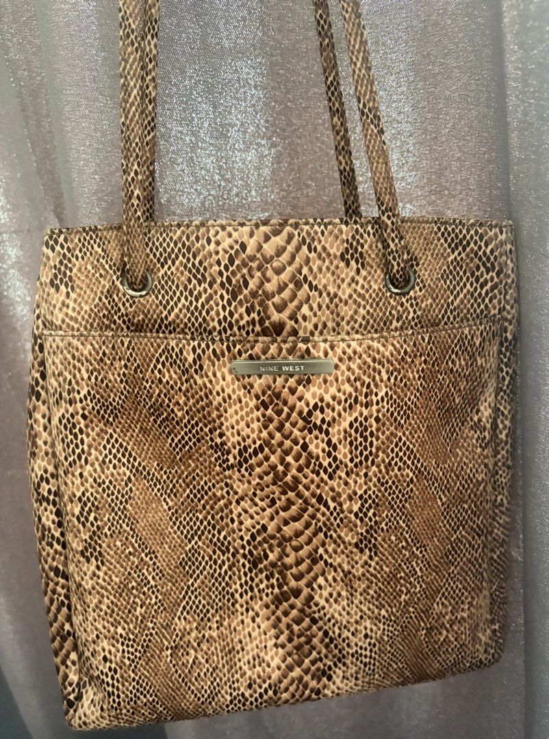 Nine West Tote Shoulder Bag (Category: Tote Bags) located in Quezon City. Submitted by rushcanon (Listing ID 1465404505, Image 2). Description: - Brand: Nine West - Condition: Clean inside and out with minimal signs of wear, perfect for everyday use 7.5/10 -Size: fits an iPad (10.2) - Material/Design: Chic brown snakeskin print with structured shape - Hardware: Silver-tone rings and metal brand plate - Straps: Double shoulder straps - Compartment