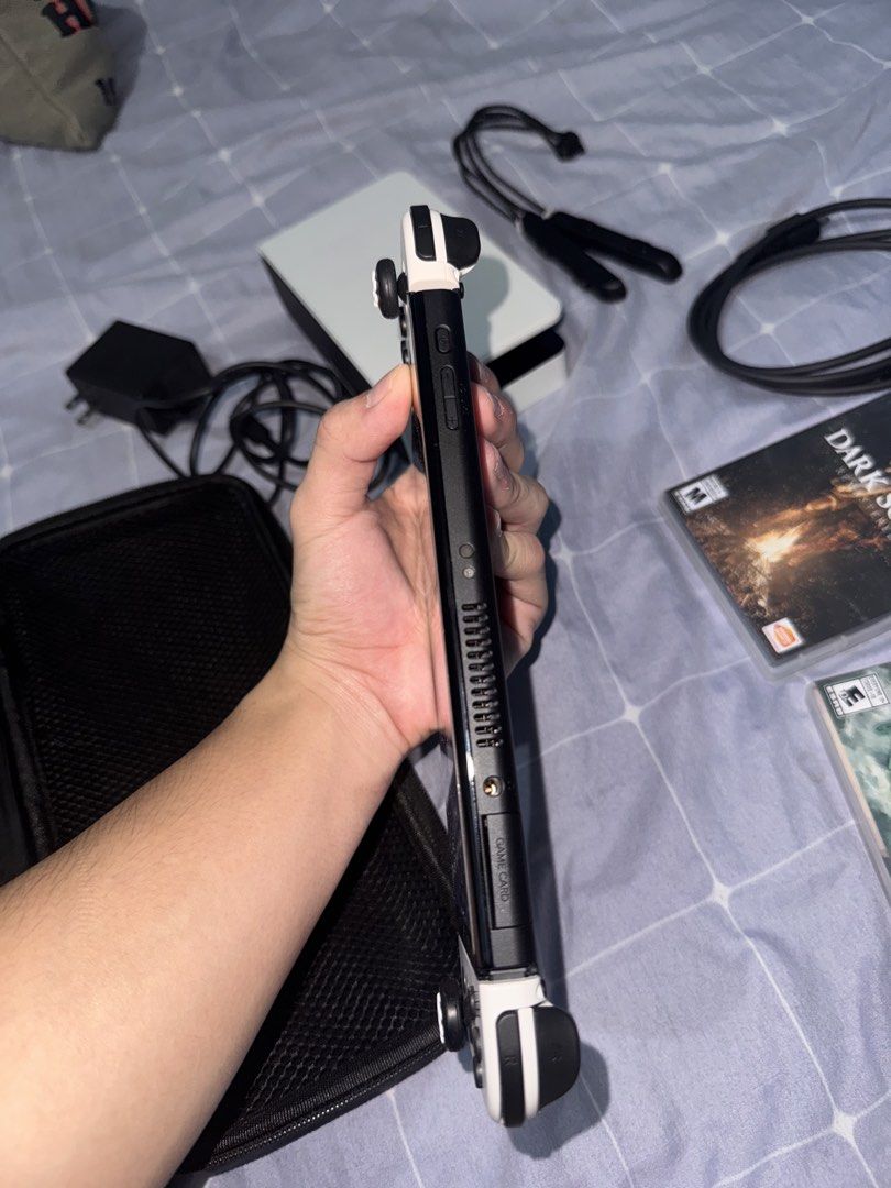 Nintendo Switch OLED Model White with Games and Accessories (Category: Nintendo) located in Manila. Submitted by jvc.do (Listing ID 1465446456, Image 3). Description: ALL IN‼️ - Nintendo Switch OLED Console (White) in 100% working condition - Screen powers on normally with no issues - Includes original dock, power adapter, and HDMI cable - Comes with white Joy-Con and two wrist straps - Includes a protective black carrying case and thumb grips at