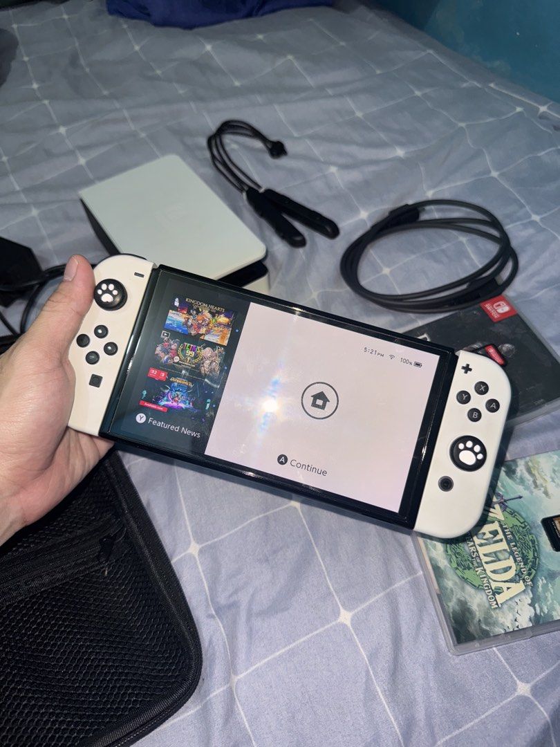 Nintendo Switch OLED Model White with Games and Accessories (Category: Nintendo) located in Manila. Submitted by jvc.do (Listing ID 1465446456, Image 2). Description: ALL IN‼️ - Nintendo Switch OLED Console (White) in 100% working condition - Screen powers on normally with no issues - Includes original dock, power adapter, and HDMI cable - Comes with white Joy-Con and two wrist straps - Includes a protective black carrying case and thumb grips at