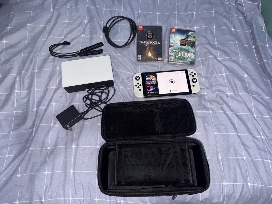 Nintendo Switch OLED Model White with Games and Accessories (Category: Nintendo) located in Manila. Submitted by jvc.do (Listing ID 1465446456, Image 1). Description: ALL IN‼️ - Nintendo Switch OLED Console (White) in 100% working condition - Screen powers on normally with no issues - Includes original dock, power adapter, and HDMI cable - Comes with white Joy-Con and two wrist straps - Includes a protective black carrying case and thumb grips at