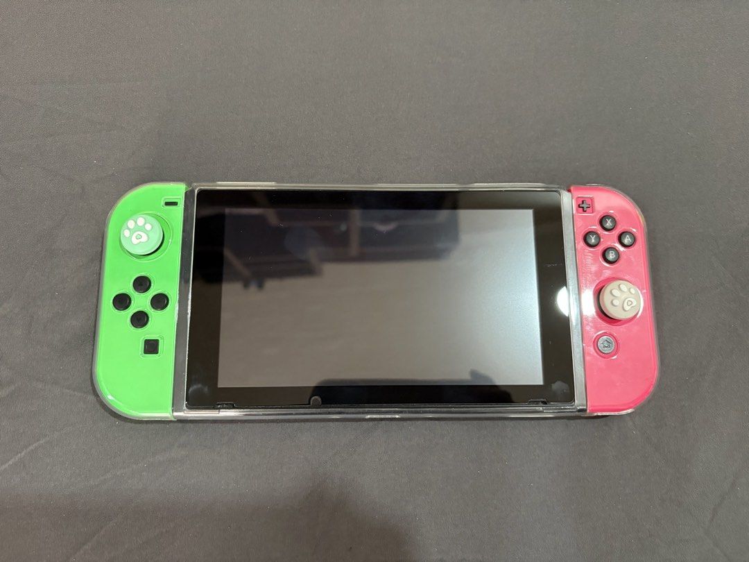 Nintendo Switch V1 (Category: Nintendo) located in Porac. Submitted by Nini_02 (Listing ID 1465392176, Image 2). Description: Nintendo Switch V1 - Jailbreak (Offline mode only) - No Issue, unit is in good condition - Download any games thru pc - All buttons are working - Original Joycon Left & Right - 128 gb sd card - No HDMI - Original Charger - Original Dock - With controller grip accessories - With travel bag Location: Pampanga.