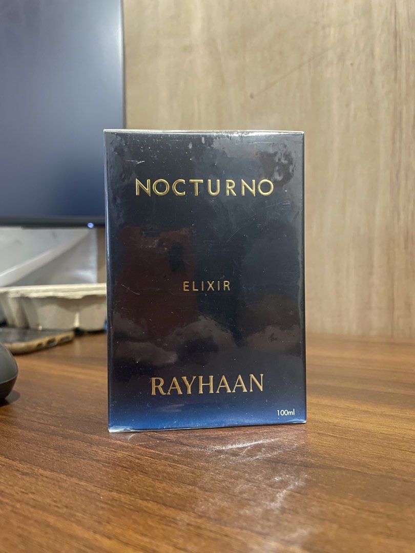 Nocturno Elixir Rayhaan Pour Homme Eau De Parfum (Category: Fragrance & Deodorants) located in Quezon City. Submitted by brave_dowayne (Listing ID 1465533419, Image 2). Description: - Brand/Fragrance: Rayhaan Nocturno Elixir pour homme - Main Accords: Aromatic, citrus, fresh spicy, woody, herbal, lavender, powdery, warm spicy, and green notes - Bottle Design: Sleek dark bottle with a blue gradient base and elegant gold lettering - Versatility: St