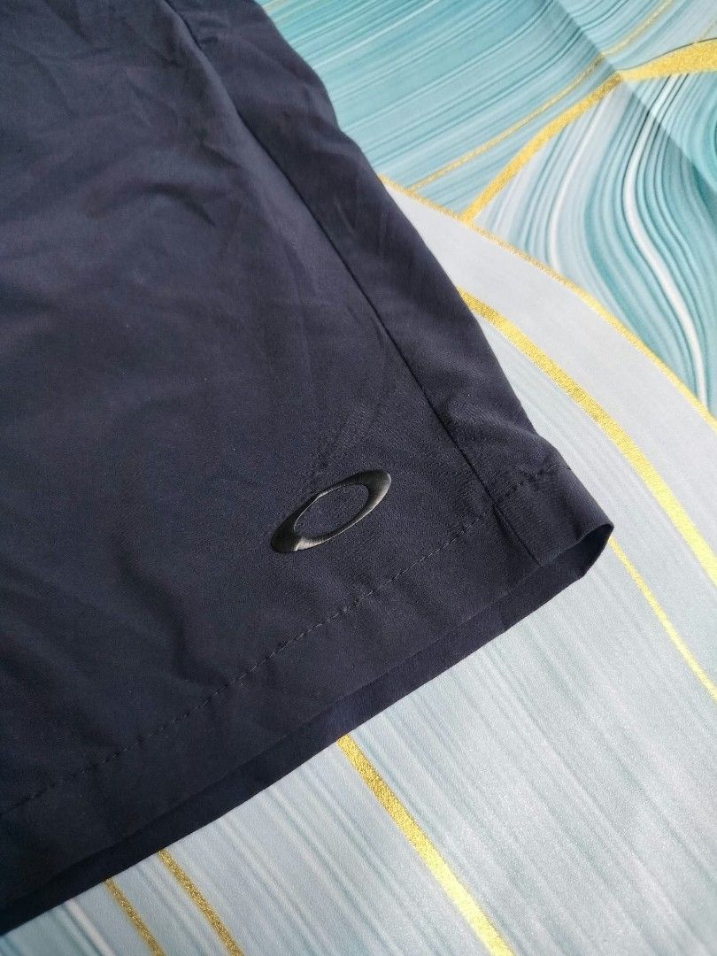 Oakley Regular Fit Shorts Size 30 Navy Blue (Category: Shorts) located in Manila. Submitted by virgiliosa38485 (Listing ID 1465495401, Image 2). Description: - Brand: Oakley - Color: Dark Navy Blue - Size: 30 (Regular Fit) -Length 20 - Material: 86% Polyester, 14% Elastane (Comfortable stretch fabric) - Design: Iconic Oakley ellipse logo on the lower left leg - Versatility: Perfect for active or casual wear - Origin: Made in Indonesia - Care: Mac