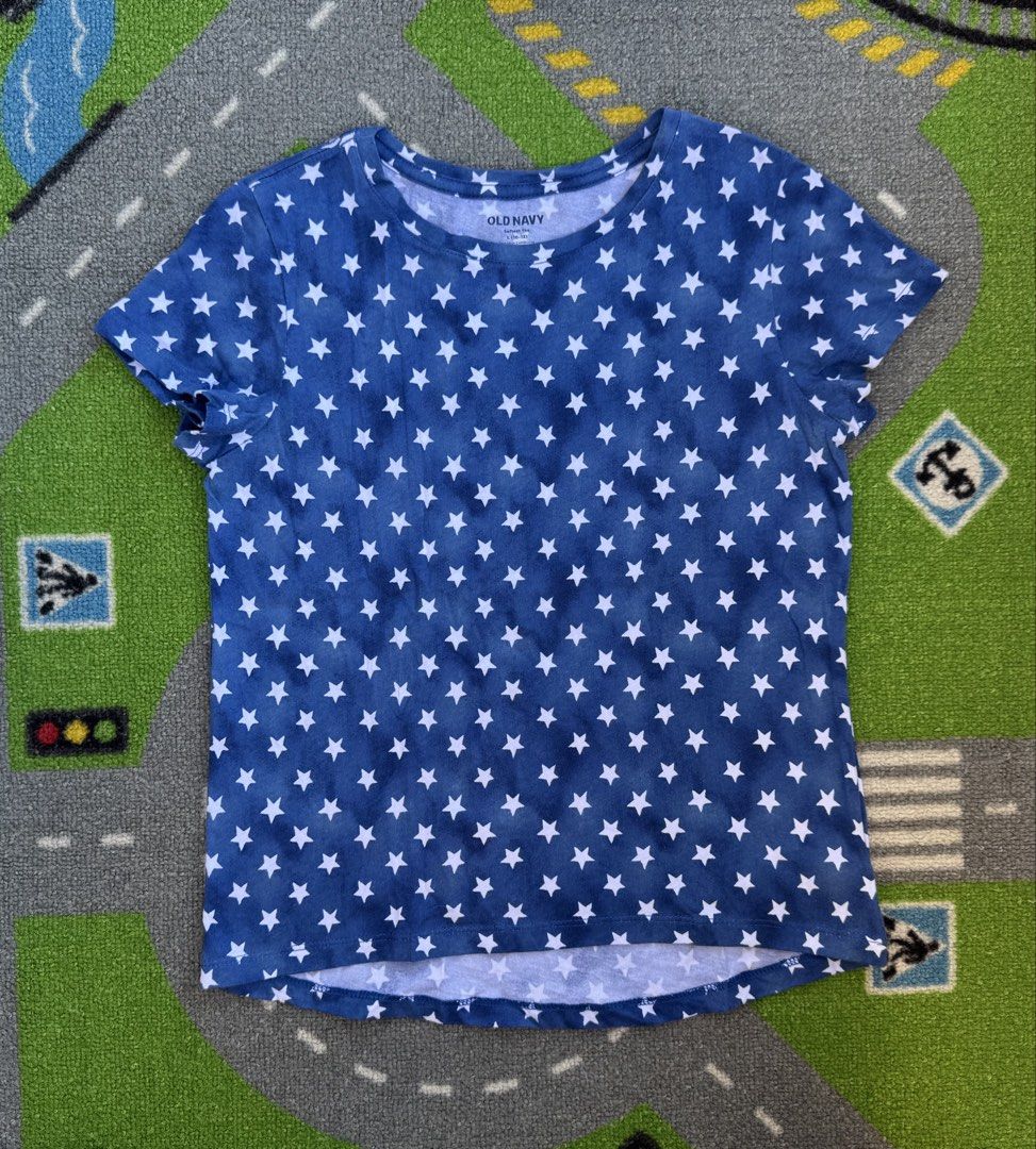 Old Navy Stars T-Shirt (Category: Babies & Kids Fashion) located in Rizal. Submitted by preloovved (Listing ID 1465484334, Image 1). Description: Super comfy Old Navy royal blue star-print tee! Features a classic crew neck, cute curved hem, and soft lightweight fabric. Perfect for casual everyday wear. Standard sizing. - Old Navy t-shirt - Blue background with white star pattern - Round neckline - Short sleeves - Lightweight fabric - Slightly cur