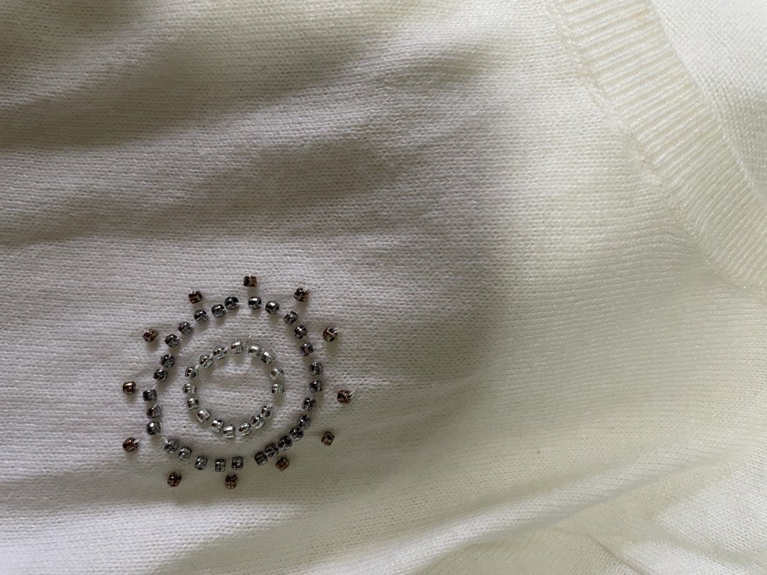Old Navy White Beaded Short Sleeve Knit Top (Category: Blouses) located in Taguig. Submitted by declutteringmom314 (Listing ID 1465387035, Image 3). Description: - Brand: Old Navy - Size: Large - Color: Solid white with silver and bronze front bead details - Material: Lightweight knit sweater fabric - Design: Short sleeves, round ribbed neckline, and ribbed cuffs - Condition: Excellent pre-loved condition (ready to wear).