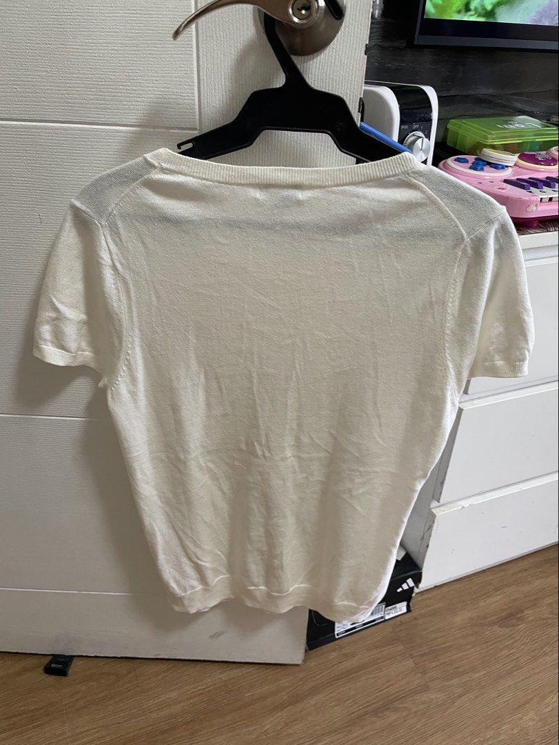 Old Navy White Beaded Short Sleeve Knit Top (Category: Blouses) located in Taguig. Submitted by declutteringmom314 (Listing ID 1465387035, Image 2). Description: - Brand: Old Navy - Size: Large - Color: Solid white with silver and bronze front bead details - Material: Lightweight knit sweater fabric - Design: Short sleeves, round ribbed neckline, and ribbed cuffs - Condition: Excellent pre-loved condition (ready to wear).