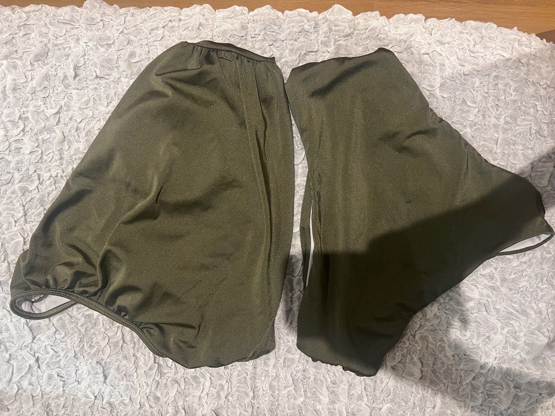 Olive Green Swim Trunks (Category: Swim Trunks & Board Shorts) located in Manila. Submitted by abiareemab80400 (Listing ID 1465456338, Image 2). Description: - Color: Solid olive green - Material: Smooth, lightweight synthetic fabric - Design: Simple pull-on style - Waistband: Elastic on one side, standard straight cut on the other - Ideal for: Beach days, swimming pools, and casual lounging - Can fit M/L - Never worn.