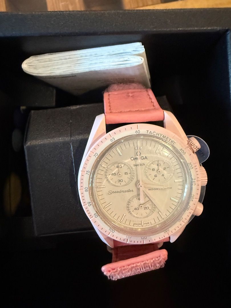 OMEGA X SWATCH MOONSWATCH PINK (Category: Luxury Watches) located in Quezon City. Submitted by ilabluxe (Listing ID 1465393310, Image 2). Description: - 100% Authentic Omega X Swatch MoonSwatch (Pink edition) - Eye-catching pink bioceramic case, matching pink dial, and comfortable pink velcro strap with film sticker - Features functional chronograph sub-dials at 2, 6, and 10 o'clock - Classic tachymetre scale on the bezel - Complete set: includes