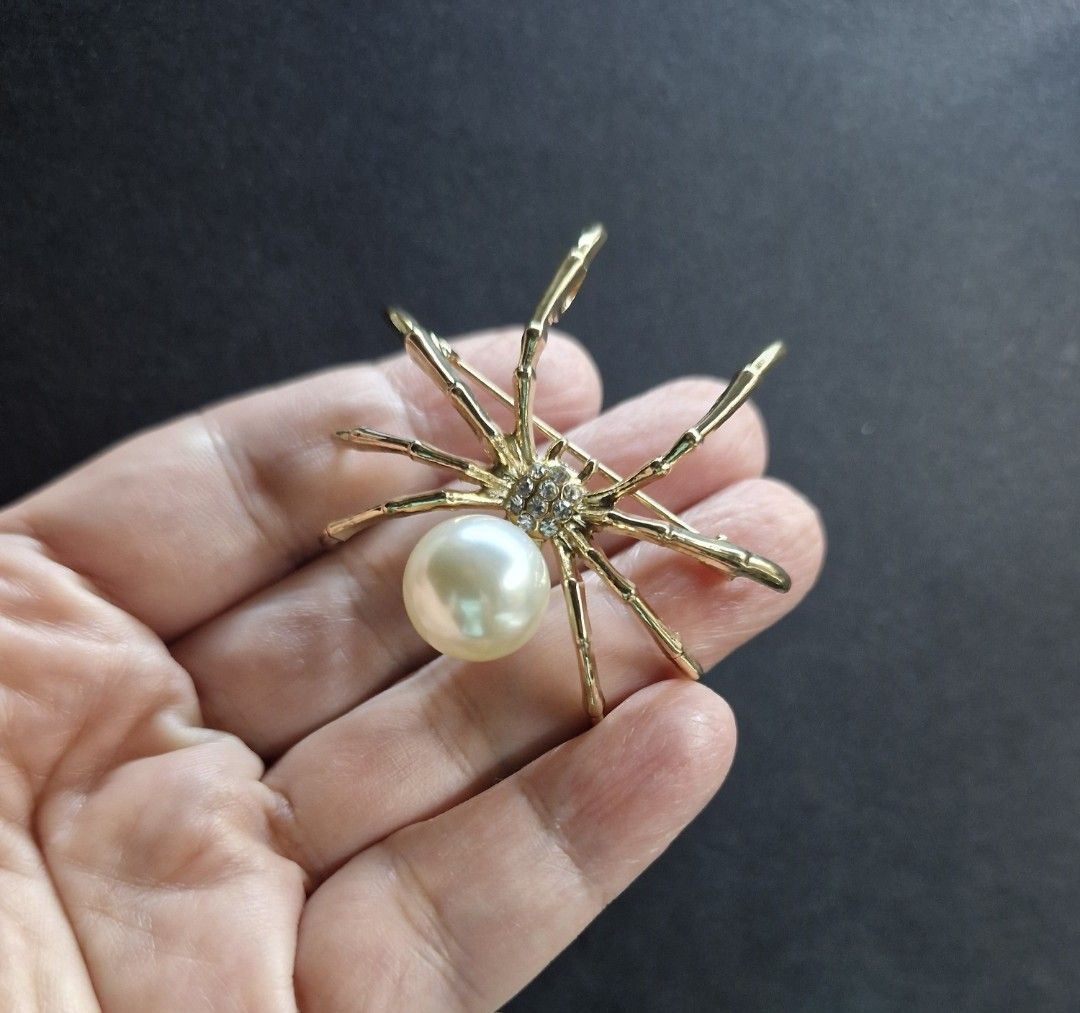 Orb Spider Brooch 2 (Category: Brooches) located in Taguig. Submitted by mommaschoice (Listing ID 1465510075, Image 2). Description: Brand New Unisex use Gold-Tone finish Adorned w/ faux pearl and rhinestones Lightweight won't damage the fabric Ships nationwide.