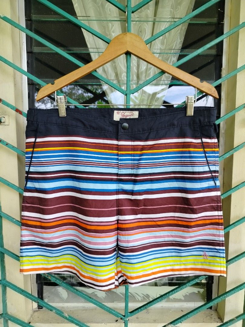 Original Penguin Striped Board Shorts Size 34 (Category: Swim Trunks & Board Shorts) located in Manila. Submitted by gerald_quinto (Listing ID 1465470598, Image 1). Description: - Brand: Original Penguin - Size: 34 - Design: Multi-color horizontal stripes (blue, maroon, orange, yellow, white) with a solid black waistband - Closure: Secure snap button closure - Pockets: Two convenient rear flap pockets - Details: Embroidered pink penguin logo near