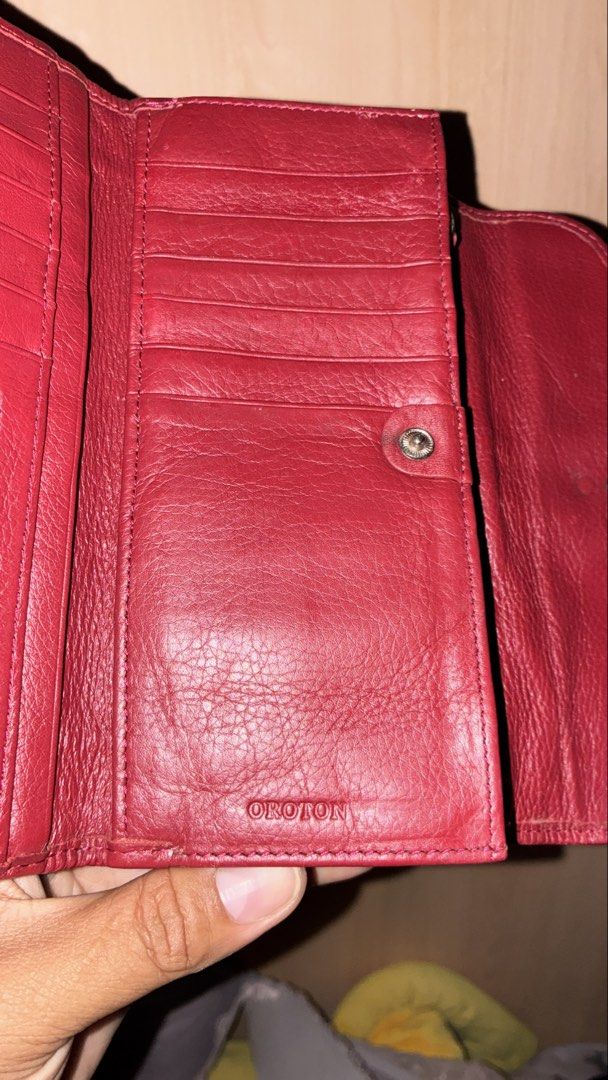 Oroton Red Leather and Monogram Long Wallet (Category: Wallets & Card holders) located in Placer. Submitted by talaalond61563 (Listing ID 1465425421, Image 3). Description: - Authentic Oroton wallet in vibrant red leather - Chic beige monogram fabric panel on the front flap - Secure silver-tone ring buckle closure - Multiple card slots and convenient ID window - Spacious bill slots and a secure coin zip compartment - Clean interior with embossed 