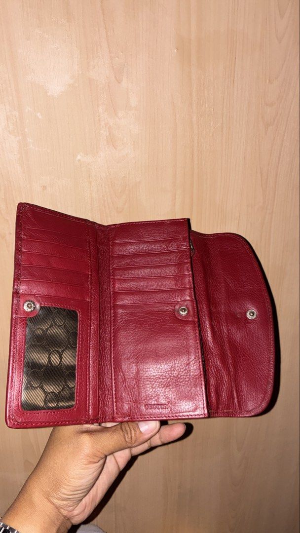 Oroton Red Leather and Monogram Long Wallet (Category: Wallets & Card holders) located in Placer. Submitted by talaalond61563 (Listing ID 1465425421, Image 2). Description: - Authentic Oroton wallet in vibrant red leather - Chic beige monogram fabric panel on the front flap - Secure silver-tone ring buckle closure - Multiple card slots and convenient ID window - Spacious bill slots and a secure coin zip compartment - Clean interior with embossed 