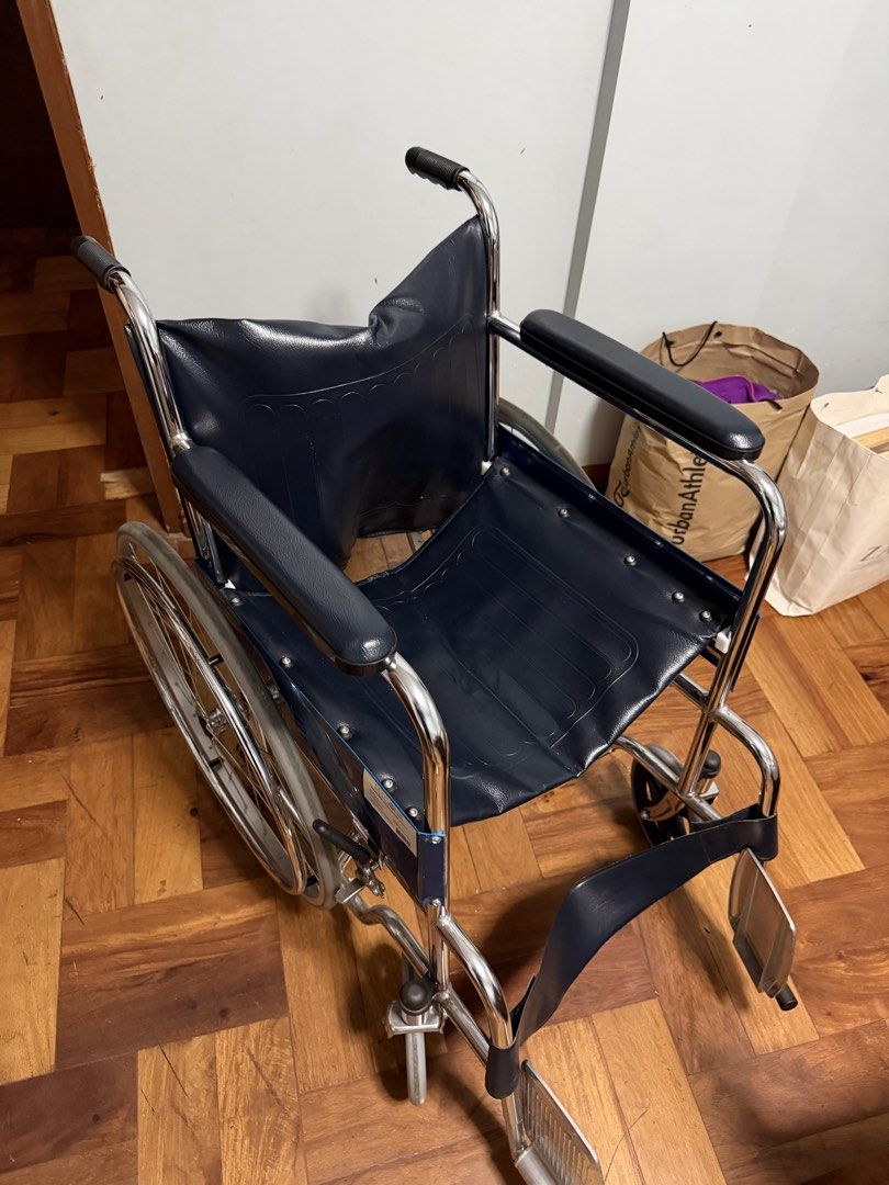 Persona Standard Wheelchair AMB809 Blue (Category: Wheelchairs) located in Taytay. Submitted by bonaventejill (Listing ID 1465548021, Image 2). Description: - Frame: Durable chrome-plated steel, clean and rust-free - Upholstery: Dark blue vinyl on seat and backrest, fully intact - Comfort: Padded armrests and attached front footrests - Mobility: Large spoked rear wheels and smooth front casters - Condition: Excellent, clean, and ready for use.