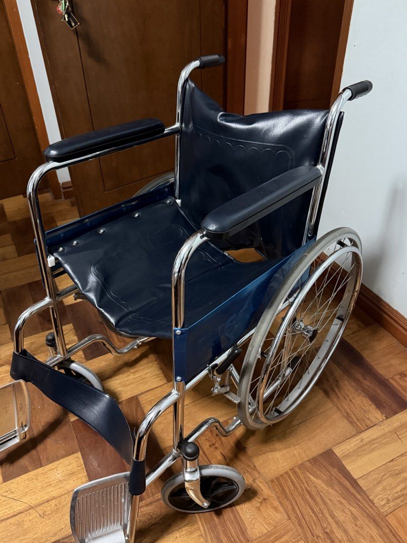 Persona Standard Wheelchair AMB809 Blue (Category: Wheelchairs) located in Taytay. Submitted by bonaventejill (Listing ID 1465548021, Image 3). Description: - Frame: Durable chrome-plated steel, clean and rust-free - Upholstery: Dark blue vinyl on seat and backrest, fully intact - Comfort: Padded armrests and attached front footrests - Mobility: Large spoked rear wheels and smooth front casters - Condition: Excellent, clean, and ready for use.