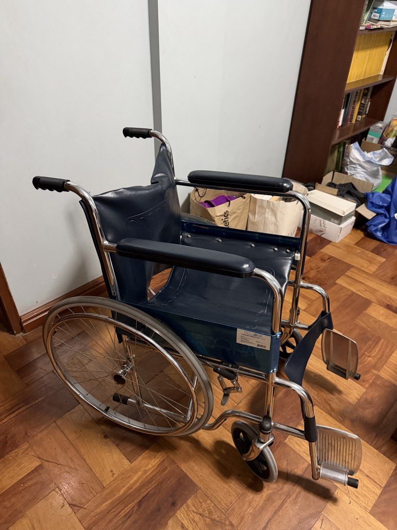 Persona Standard Wheelchair AMB809 Blue (Category: Wheelchairs) located in Taytay. Submitted by bonaventejill (Listing ID 1465548021, Image 1). Description: - Frame: Durable chrome-plated steel, clean and rust-free - Upholstery: Dark blue vinyl on seat and backrest, fully intact - Comfort: Padded armrests and attached front footrests - Mobility: Large spoked rear wheels and smooth front casters - Condition: Excellent, clean, and ready for use.