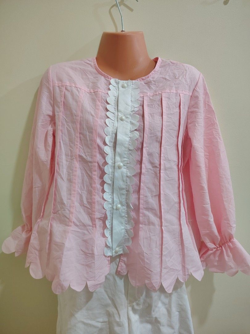 Pink blouse with white button placket and scalloped hem (Category: Blouses) located in Quezon City. Submitted by timelesstreasure117 (Listing ID 1465549520, Image 1). Description: Can fit from XS to Ismall Good condition ₱70 Bundle with my other top listings to get discount 5 for ₱300 10 for ₱500 Buyer books courier of choice Payment via gcash or paymaya.