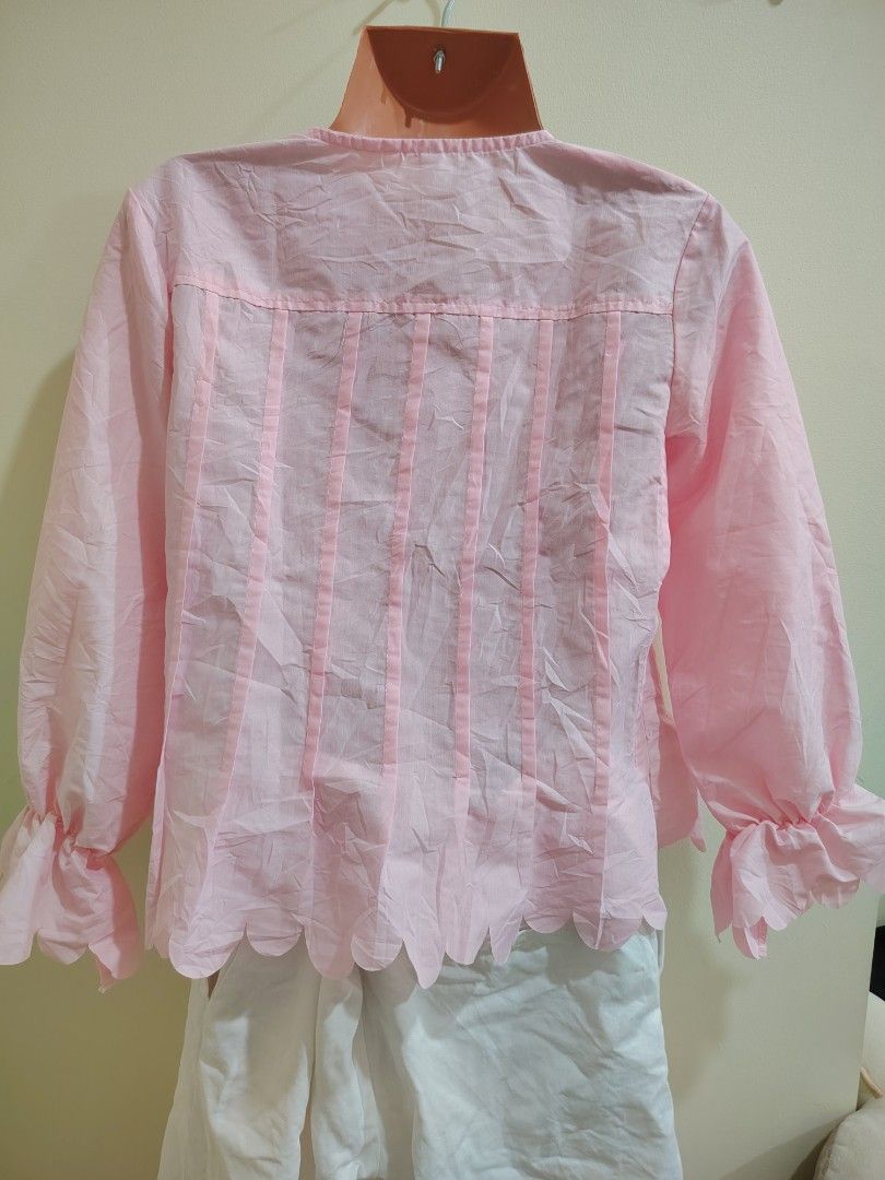 Pink blouse with white button placket and scalloped hem (Category: Blouses) located in Quezon City. Submitted by timelesstreasure117 (Listing ID 1465549520, Image 2). Description: Can fit from XS to Ismall Good condition ₱70 Bundle with my other top listings to get discount 5 for ₱300 10 for ₱500 Buyer books courier of choice Payment via gcash or paymaya.