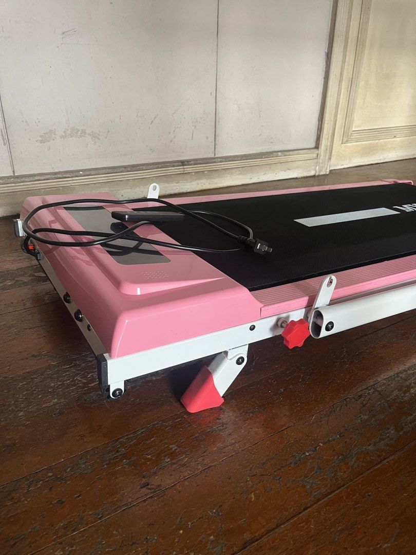 Pink MY-HI Treadmill/Walking pad (Category: Cardio & Fitness Machines) located in Makati City. Submitted by seedkneeee (Listing ID 1465398017, Image 3). Description: - Color: Stylish pink - Condition: Tested and fully working (purchased from Zone Mall) - Speed & Incline: 1-10 km/h speed range with 0-9 degree slope adjustment - Comfort: Built-in bottom shock pad to protect your joints - Convenience: Includes remote control for easy adjustments - S