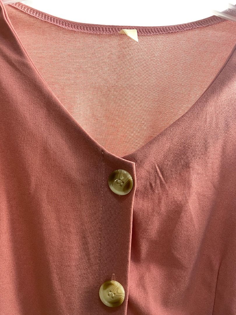 Pink V-neck short sleeve button front jumpsuit (Category: Jumpsuits) located in Quezon City. Submitted by theusualneed (Listing ID 1465436958, Image 3). Description: - Color: Dusty pink - Design: Short sleeves, V-neck, and front placket with two marbled buttons - Fit: Elastic waistband for a cinched middle and a trendy wide-leg cut - Material: Smooth fabric with a subtle texture - Condition: Excellent, clean hems with zero visible wear - Size: Sm