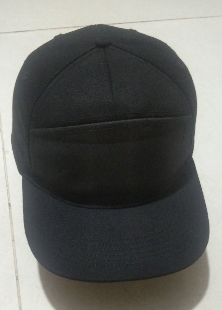 Plain Black Snapback Cap (Category: Caps & Hats) located in Quezon City. Submitted by aljonbermu25659 (Listing ID 1465395212, Image 1). Description: - Color: Solid black - Brim: Flat style - Fit: Adjustable plastic strap at the back - Construction: Structured crown panels with clean stitching - Details: Inner tag with QR code near the closure - Style: Minimalist and versatile for everyday wear.