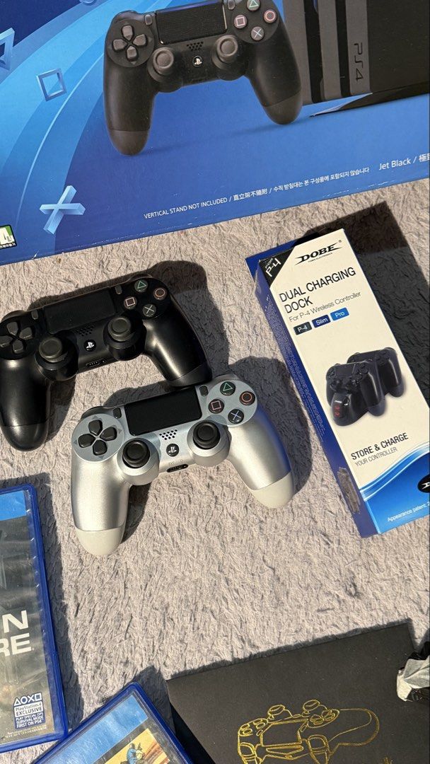 PlayStation 4 Pro 1TB Console with Controllers and Games Bundle (Category: PlayStation) located in Makati City. Submitted by jdla05 (Listing ID 1465481948, Image 2). Description: PS4 Pro 1TB console packaged in the original box. Two wireless controllers included, one black and one silver. Charging dock, custom decal pack, and power cables bundled together. Six physical games: God of War, Horizon Zero Dawn, Call of Duty Modern Warfare, PUBG, Spide