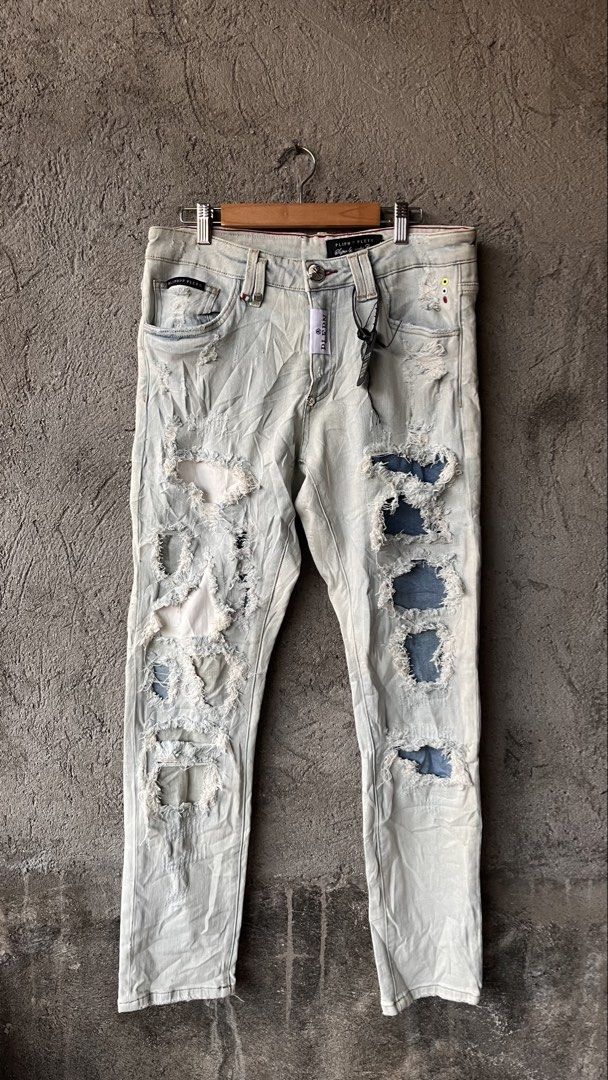 PLIPHPP PLEPN Super Straight Cut Distressed Denim Jeans (Category: Jeans) located in Cabuyao City. Submitted by bulandos (Listing ID 1465471247, Image 1). Description: - Size: 32 Waist - Fit: Super straight cut - Wash/Color: Light wash with faded treatment and heavy texture - Details: Heavy distressing, edgy rips, and unique patchwork - Hardware & Branding: Custom skull buttons and branded leather back patch - Condition: Brand new with original t