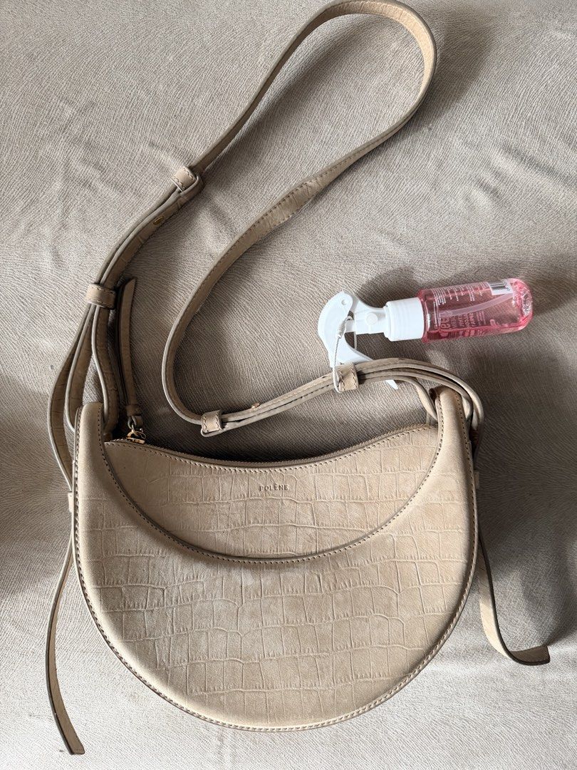 Polène Numéro Dix Suede Crocodile Embossed Bag (Category: Luxury Bags & Wallets) located in Quezon City. Submitted by hjane26 (Listing ID 1465503074, Image 1). Description: - Brand: Polène - Style: Crescent-shaped crossbody bag - Material: Beige embossed suede leather with gold-tone hardware - Closure: Top zip closure with front flap debossed logo - Strap: Adjustable crossbody strap. Comes with a shoulder strap. - Condition: Noticeable discolorat