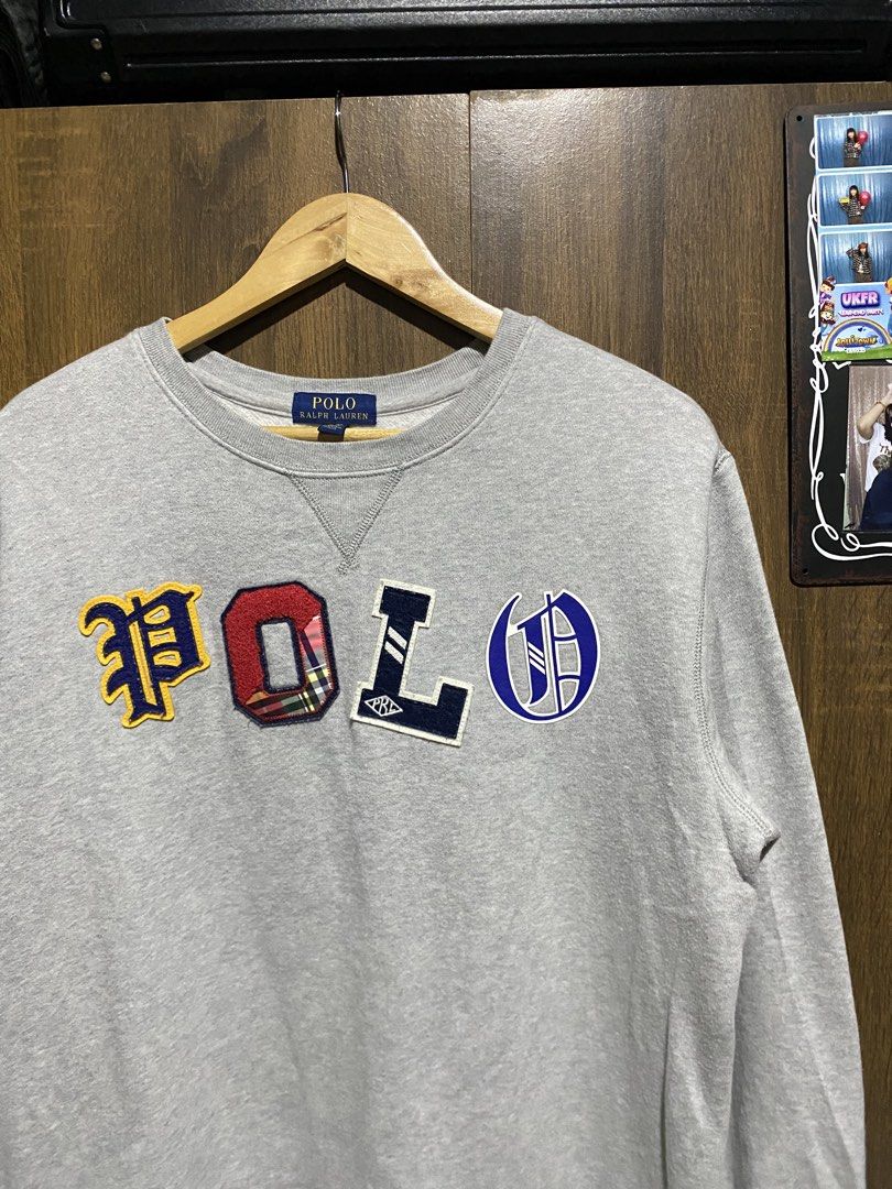 Polo Ralph Lauren Grey Patchwork Sweatshirt (Category: Coats, Jackets and Outerwear) located in Antipolo. Submitted by cogiestamaria (Listing ID 1465426939, Image 3). Description: - Brand: Polo Ralph Lauren - Color: Grey - Design: Colorful varsity letters with unique fabrics and textures across the chest, classic crewneck with collar triangle insert, ribbed cuffs and hem - Size: Youth XL (18-20), fits smaller than a standard men's Large - dimes W