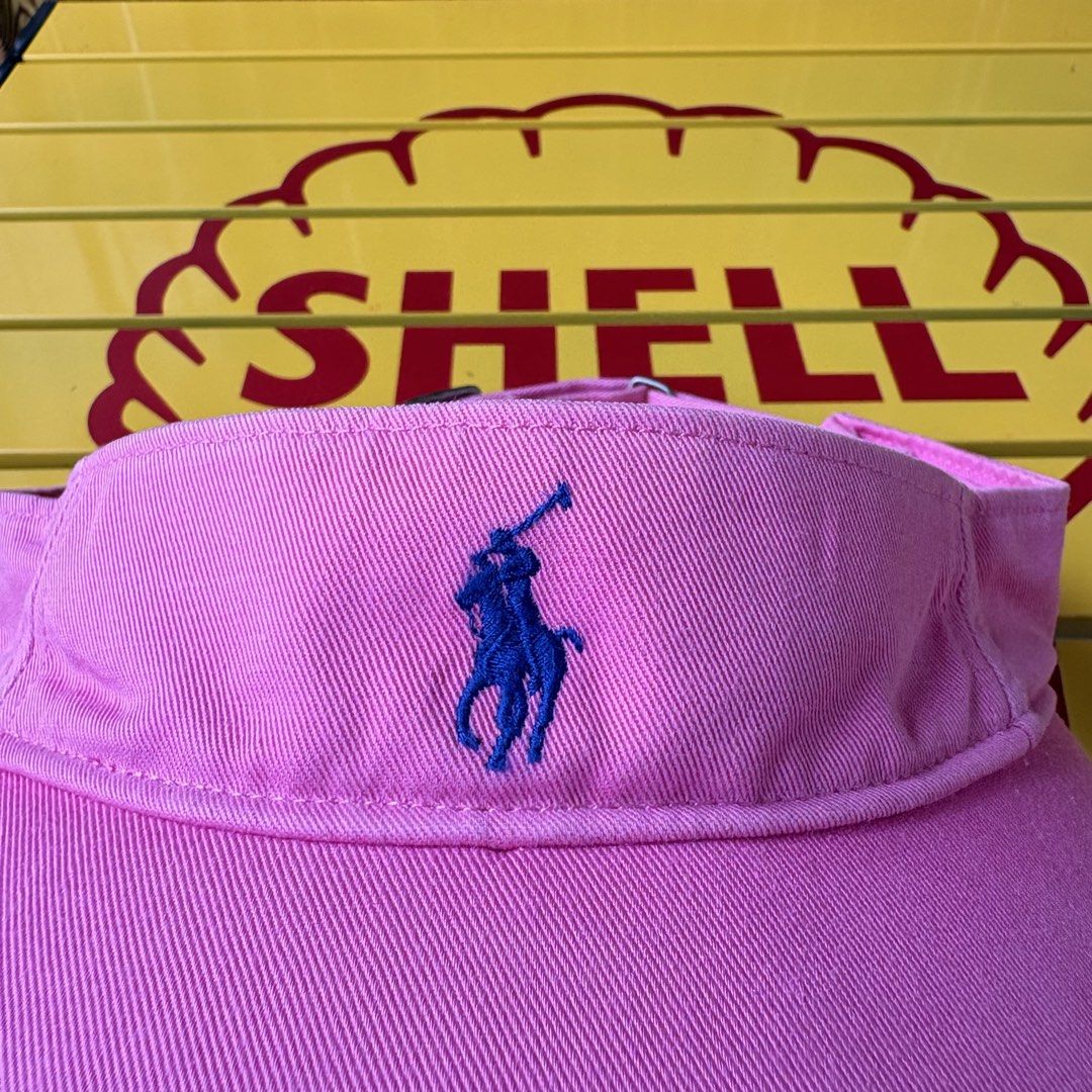 Polo Ralph Lauren Pink Sun Visor (Category: Hats & Beanies) located in Dapitan. Submitted by payt3es_thrift. (Listing ID 1465392322, Image 2). Description: - Brand: Polo Ralph Lauren - Color: Bright pink with classic blue embroidered pony - Fit: Adjustable metal strap in the back, one size fits most - Details: Navy interior label, made in China - Condition: Great shade for sunny days out!.