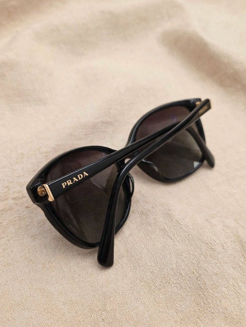 Prada (Category: Sunglasses & Eyewear) located in Cabanatuan. Submitted by peach_cams (Listing ID 1465412395, Image 3). Description: ) 🖤 PRE-LOVED: Prada SPR 01O Classic Sunglasses 🖤 Elevate your look with these timeless, high-fashion statement shades from Prada! Super elegant ng butterfly/cat-eye frame with gold-tone branding details. Brand/Model: Prada SPR 01O (PR 01OS) Color/Style: Black Acetate with Gray Gradient Lenses Details: Made in Ita