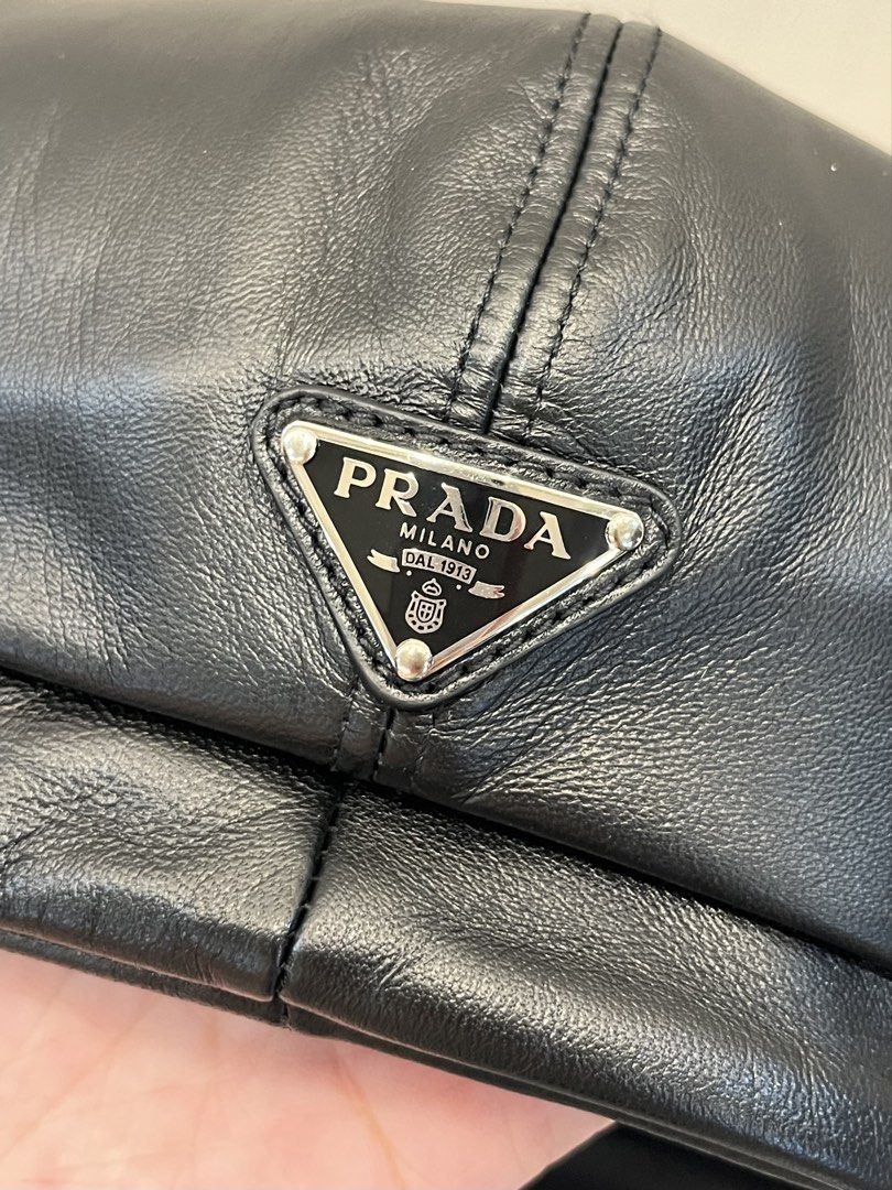 Prada Black Leather Newsboy Cap Baker Boy Hat (Category: Luxury Apparel) located in Paranaque City. Submitted by shopmnp (Listing ID 1465394094, Image 1). Description: Prada Classic baker boy cap with paneled crown, top button detail, and curved brim - Material: Black nappa leather with iconic Prada triangle logo on the back - Condition: Pristine exterior and clean interior, with tag, with box (damaged) Retailed for 8,600 Chinese Yuan = 56,000 in