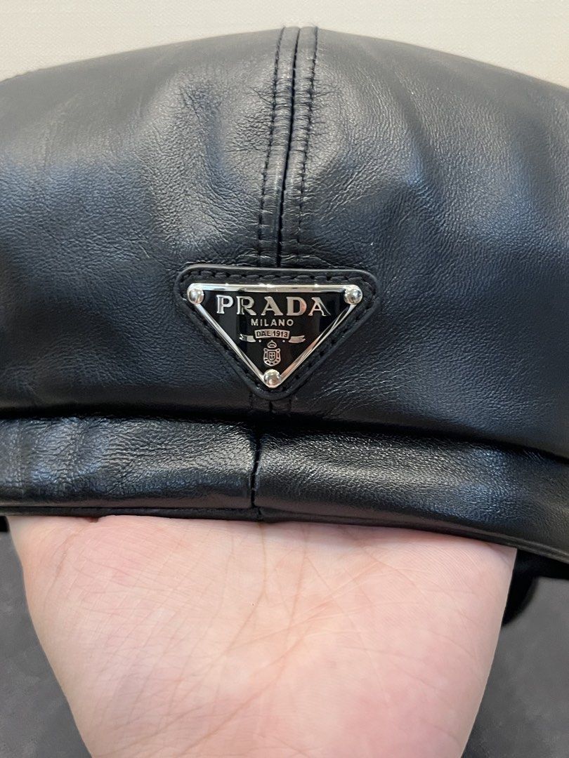 Prada Black Leather Newsboy Cap Baker Boy Hat (Category: Luxury Apparel) located in Paranaque City. Submitted by shopmnp (Listing ID 1465394094, Image 2). Description: Prada Classic baker boy cap with paneled crown, top button detail, and curved brim - Material: Black nappa leather with iconic Prada triangle logo on the back - Condition: Pristine exterior and clean interior, with tag, with box (damaged) Retailed for 8,600 Chinese Yuan = 56,000 in