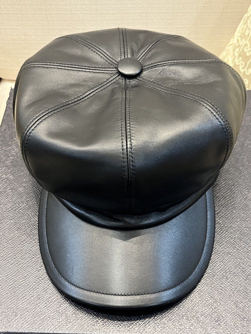 Prada Black Leather Newsboy Cap Baker Boy Hat (Category: Luxury Apparel) located in Paranaque City. Submitted by shopmnp (Listing ID 1465394094, Image 3). Description: Prada Classic baker boy cap with paneled crown, top button detail, and curved brim - Material: Black nappa leather with iconic Prada triangle logo on the back - Condition: Pristine exterior and clean interior, with tag, with box (damaged) Retailed for 8,600 Chinese Yuan = 56,000 in