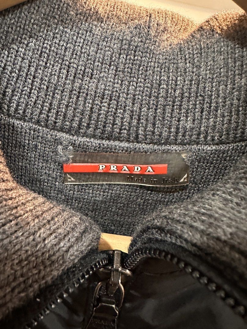 Prada Black Nylon Knit Panel Zip Jacket (Category: Coats, Jackets and Outerwear) located in Bulacan. Submitted by adoseofluxxee (Listing ID 1465482631, Image 3). Description: - Brand: Prada - Color: Black nylon with grey knit collar and side panels - Size: 46 (Made in Italy) - Details: Full zip front with branded hardware and iconic red logo tab on the sleeve - Condition: Clean, comfortable, and premium hybrid build.