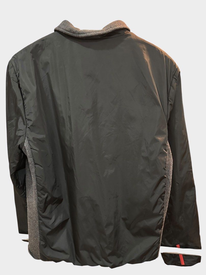 Prada Black Nylon Knit Panel Zip Jacket (Category: Coats, Jackets and Outerwear) located in Bulacan. Submitted by adoseofluxxee (Listing ID 1465482631, Image 2). Description: - Brand: Prada - Color: Black nylon with grey knit collar and side panels - Size: 46 (Made in Italy) - Details: Full zip front with branded hardware and iconic red logo tab on the sleeve - Condition: Clean, comfortable, and premium hybrid build.