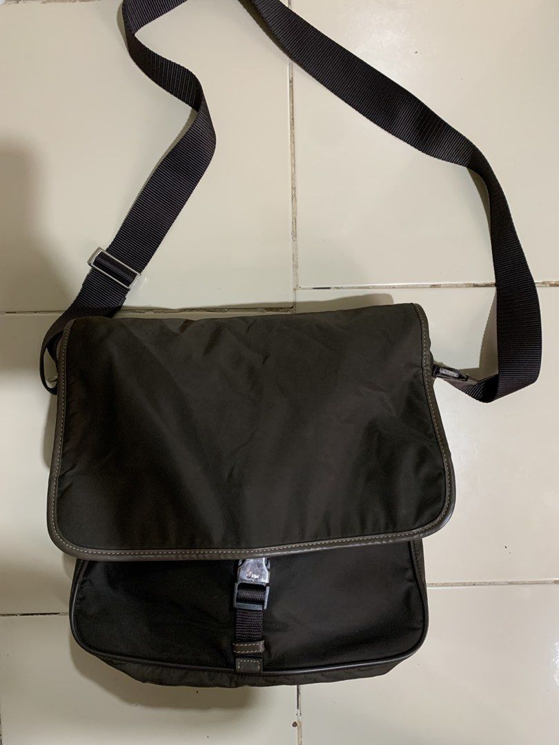 Prada Tessuto Buckle messenger bag (Category: Sling Bags) located in Davao. Submitted by archivecollection (Listing ID 1465429001, Image 1). Description: Prada Tessuto Buckle messenger cross body bag No issue Very Good condition Color : dark brown 13 inches Length 12 inches width Dm for more details .