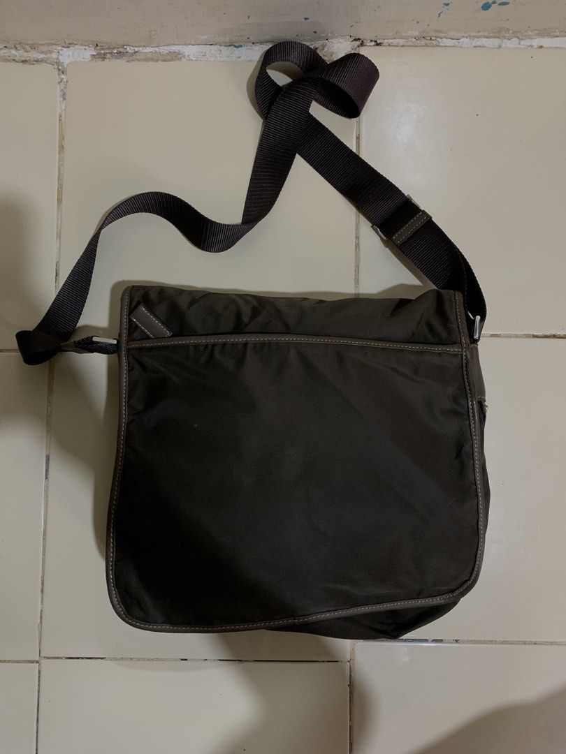 Prada Tessuto Buckle messenger bag (Category: Sling Bags) located in Davao. Submitted by archivecollection (Listing ID 1465429001, Image 2). Description: Prada Tessuto Buckle messenger cross body bag No issue Very Good condition Color : dark brown 13 inches Length 12 inches width Dm for more details .