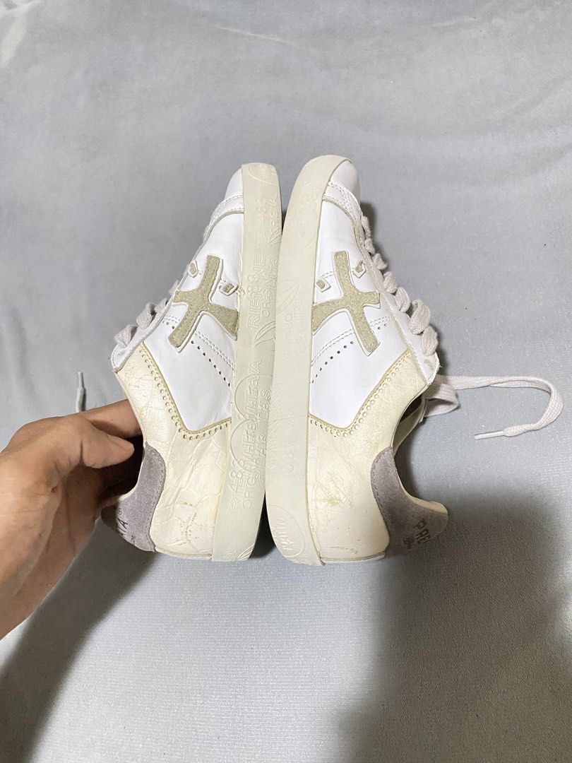 Premiata White Bespoke Trainer Sneakers (Category: Sneakers) located in Barobo. Submitted by sonogonggr22560 (Listing ID 1465502024, Image 3). Description: - issue: replace sole pad - Brand: Premiata Bespoke - Color: White with light grey and gold accents - Material: Premium textured leather upper with suede heel counter - Features: Distinctive side cross logo, gold branding on heel, and unique printed textured midsole - Closure: Classic lace-up 
