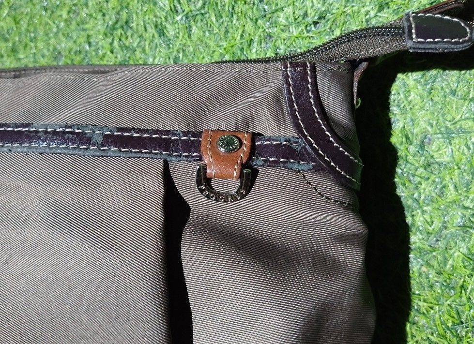 Progrès Crossbody Bag Brown Nylon (Category: Cross-body Bags) located in Manila. Submitted by patrickjos06722 (Listing ID 1465510378, Image 3). Description: - Brand: Progrès - Material: Durable brown nylon with stylish leather-style trim - Design: Compact everyday crossbody and shoulder bag - Strap: Adjustable for a custom, comfortable fit - Pockets: Secure top zipper closure, exterior back zip pocket, and multiple interior storage compartments -