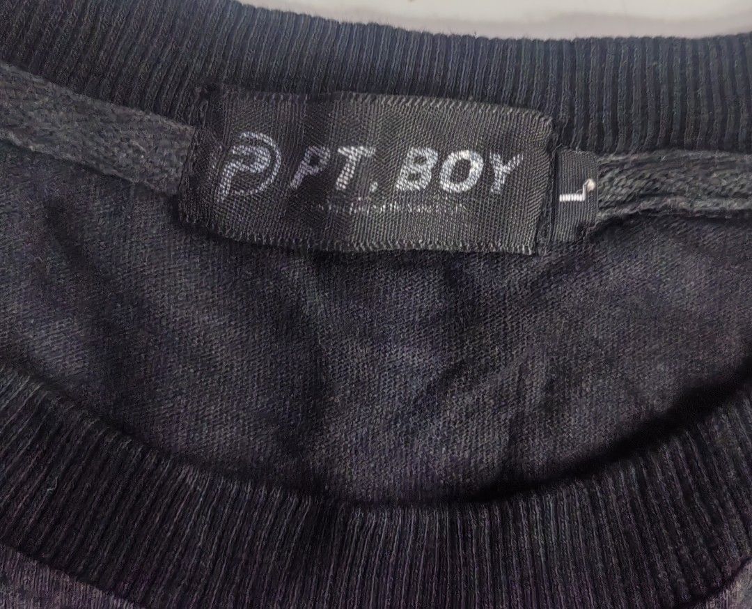 PTBOY Graphic Print Black Tank Top (Category: Tshirts & Polo Shirts ) located in Manila. Submitted by livedolphin_68dee2 (Listing ID 1465485904, Image 3). Description: - Brand: PTBOY - Style: Black sleeveless tank top with a bold streetwear/vintage aesthetic - Design Front: "PAINFULLY" arched over a gothic cross graphic - Design Back: Large graphic print of a figure with "1998", clouds, and green crosses - Fabric: Heavy distressed acid wash textu